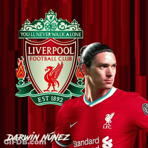 Darwin Nunez Stands In Front Of A Liverpool Football Club Poster GIF