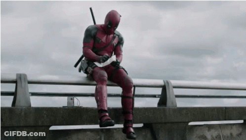 Deadpool Man Sitting On Railing Holding Paper GIF
