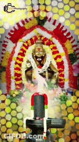 Deity Statue Surrounded By Flowers Saying Photography GIF