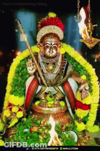 Deity Statue With Sword And Flowers GIF