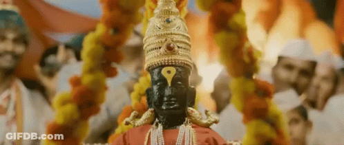 Deity Statue With Yellow Eye And Gold Hat GIF