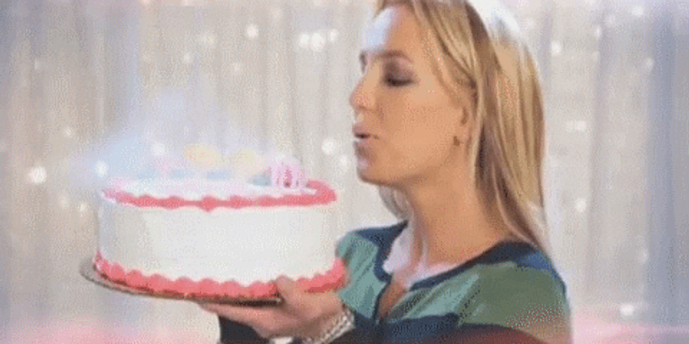Demure Britney Spears Holding A Cake GIF