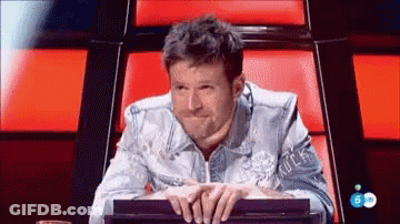 Denim Jacket Man Hands Folded On Red Chair GIF