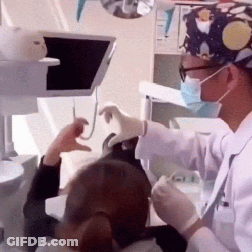 Dentist Examining Woman's Teeth GIF