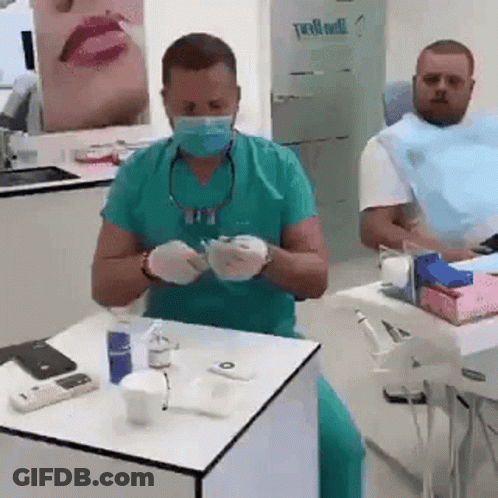 Dentist Preparing To Treat Patient With Mask And Gloves GIF