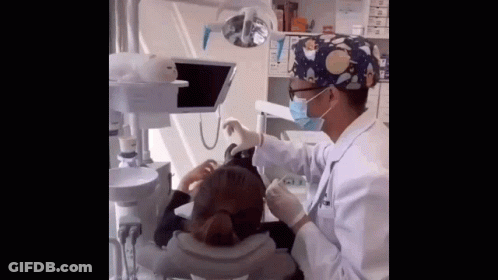 Dentist Working On Patient's Teeth GIF