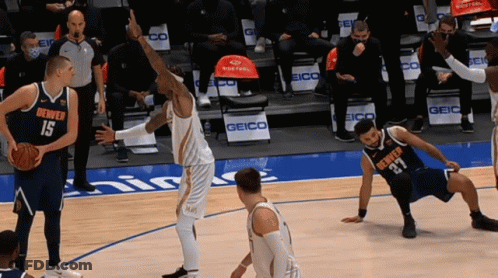Denver Players 15 And 27 Are Playing Basketball On A Court GIF