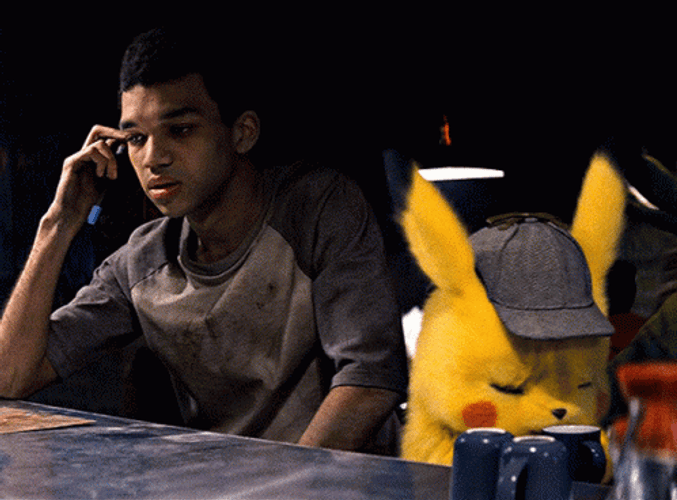 Detective Pikachu Sitting Beside Harry Goodman GIF