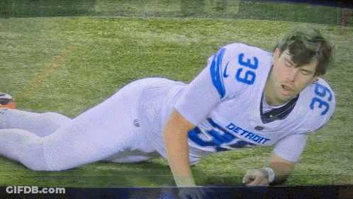 Detroit Football Player Laying On Ground GIF