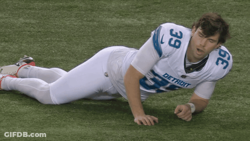 Detroit Football Player Laying On Ground GIF