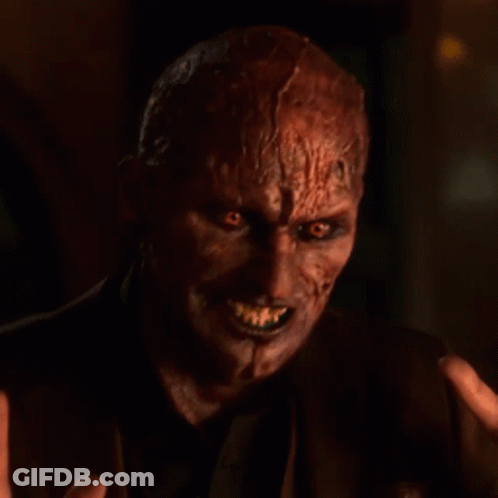 Devil Face Close Up With Hand Reaching Out GIF