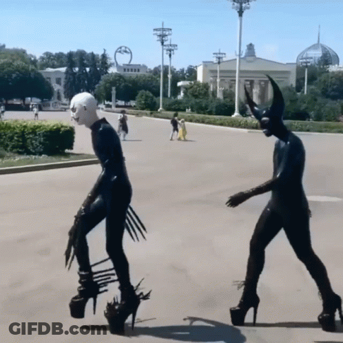 Devil Statue With Horns Walking Down Street GIF