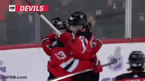 Devils Hockey Players Hugging In Front Of SN Logo GIF