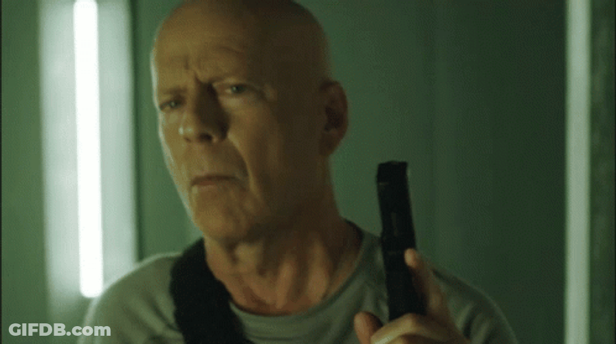 Die Hard Holding A Gun Searching GIF