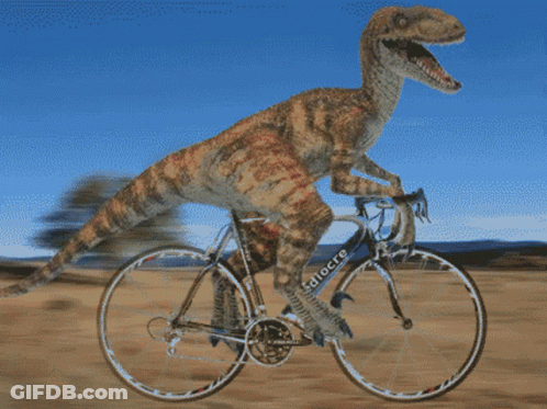 Dinosaur Riding Bicycle With Word Focus On Front Wheel GIF