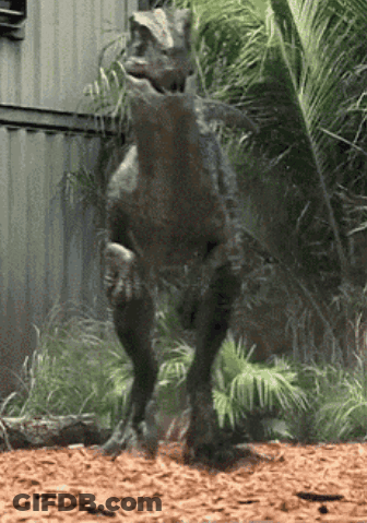 Dinosaur Statue In Front Of Building GIF
