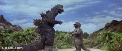 Dinosaur Statue Standing Next To Another GIF