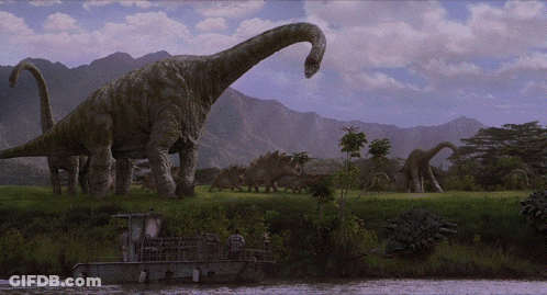 Dinosaurs Standing In Field Near River GIF