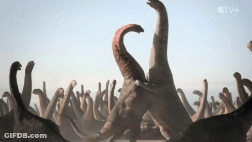 Dinosaurs Standing Next To Apple TV+ Logo GIF