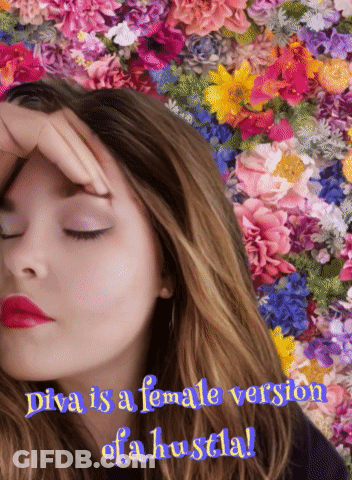 Diva Is A Female Version Of A Hustla With A Woman In Front Of Flowers GIF