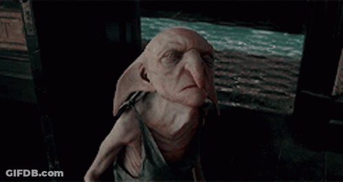Dobby From Harry Potter Sitting In Dark Room GIF