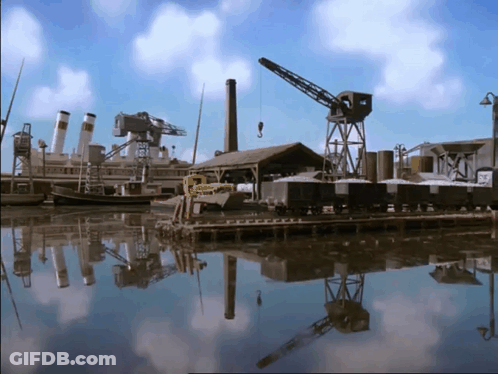 Dock With Boats, Crane, And Building Reflection GIF