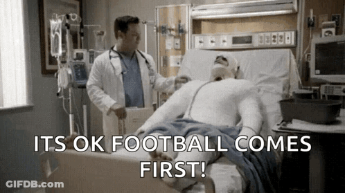 Doctor Examining Man In Hospital Bed Football Comes First GIF