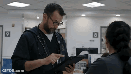 Doctor Talking To Nurse Holding Tablet GIF