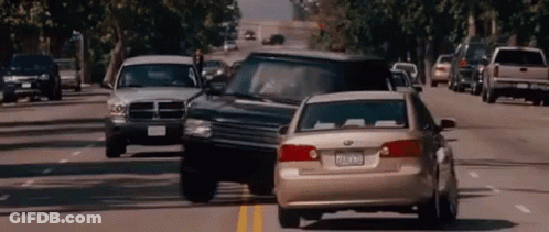 Dodge Ram Truck Driving Down Busy Street GIF