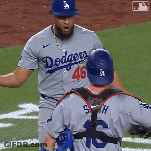 Dodgers Player High Fives Teammate In Front Of Win Sign GIF