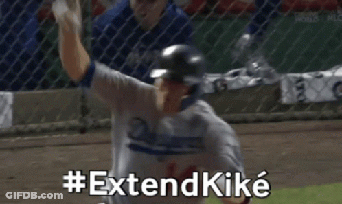Dodgers Player Raising Arm While Teammate Looks On GIF