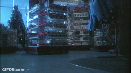 Dog In Front Of Christmas Tree With Survive Boxes GIF
