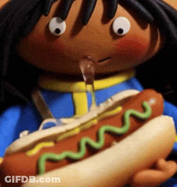 Doll Holding Hot Dog With Green Mustard GIF