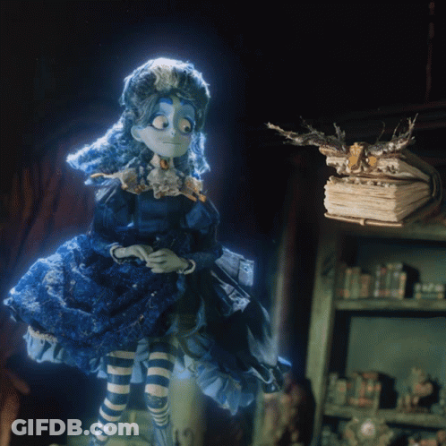 Doll In Blue Dress Next To Pile Of Books GIF