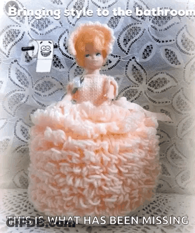 Doll In Pink Dress Sitting On Toilet Paper Caption Bringing Style To The Bathroom GIF