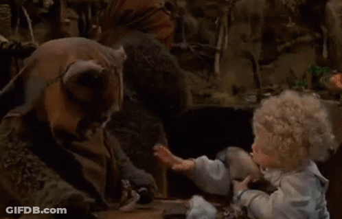 Doll Sitting At Table Talking To Stuffed Animal GIF