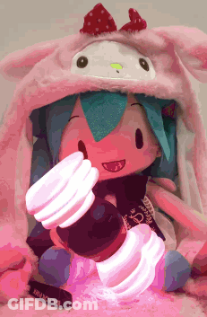 Doll Wearing Hello Kitty Hat Holding Light GIF