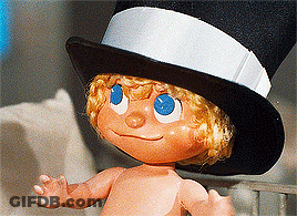 Doll With Blue Eyes And Top Hat GIF