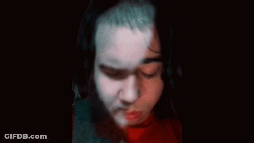 Doll With Pins On Face And Neck GIF