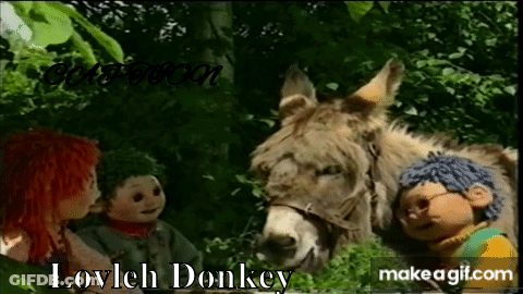 Dolls Standing Next To Donkey In Forest GIF