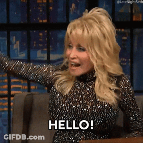 Dolly Parton Is Sitting In A Chair With Her Arms Outstretched And Says Hello ! GIF
