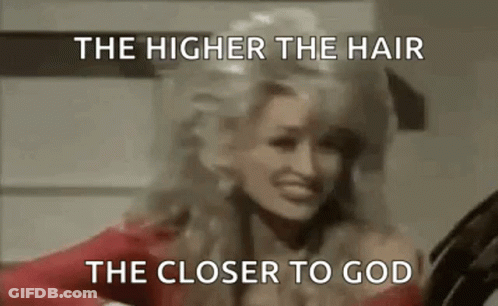 Dolly Parton Is Wearing A Red Dress And Has A Wig On . GIF