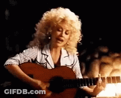 Dolly Parton Singing And Playing Guitar In Dark Room GIF