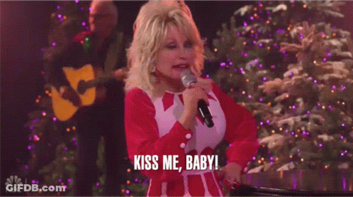 Dolly Parton Singing Into Microphone Saying Kiss Me Baby GIF