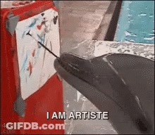 Dolphin Pointing Needle At Painting Saying I Am Artiste GIF
