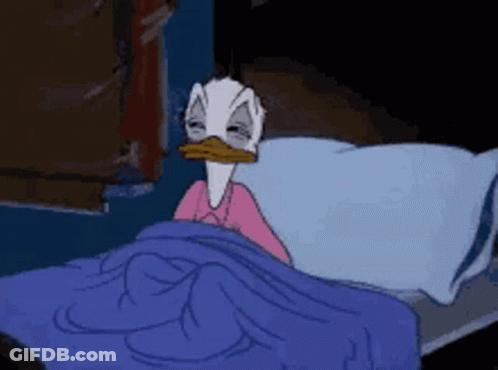 Donald Duck Is Laying In A Bed With A Blue Blanket GIF