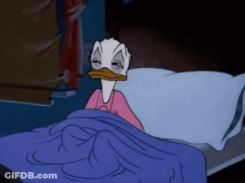 Donald Duck Is Laying In A Bed With His Eyes Closed GIF