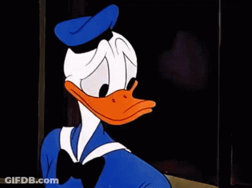 Donald Duck Is Making A Stop Sign With His Hand While Sitting At A Table . GIF