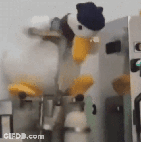 Donald Duck Stuffed Animal Sitting On Machine GIF