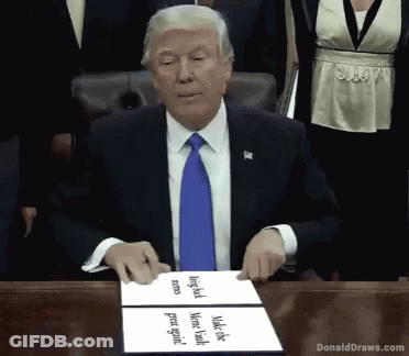 Donald Trump At Table With Donald Draws.com Sign GIF